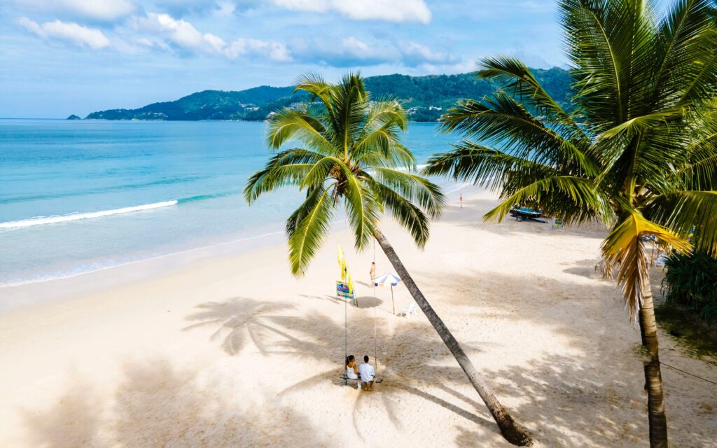Bang Tao Beach during sunset in Phuket Thailand, palm trees during sunset on the beach