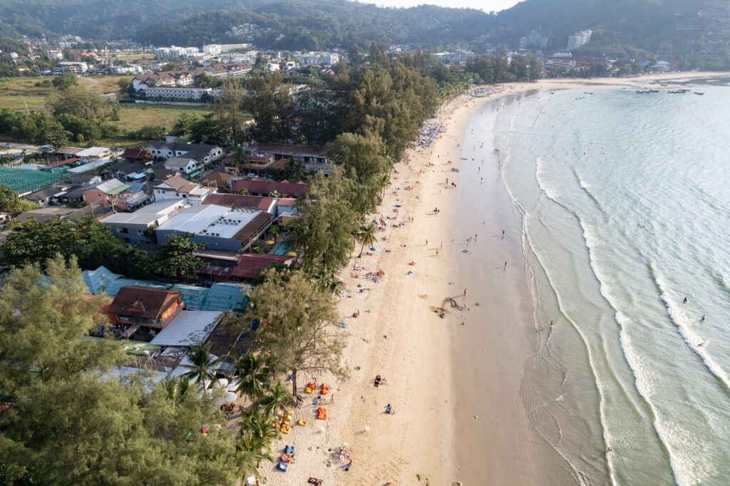View of Kamala Beach in Phuket, surrounded by lush tropical vegetation